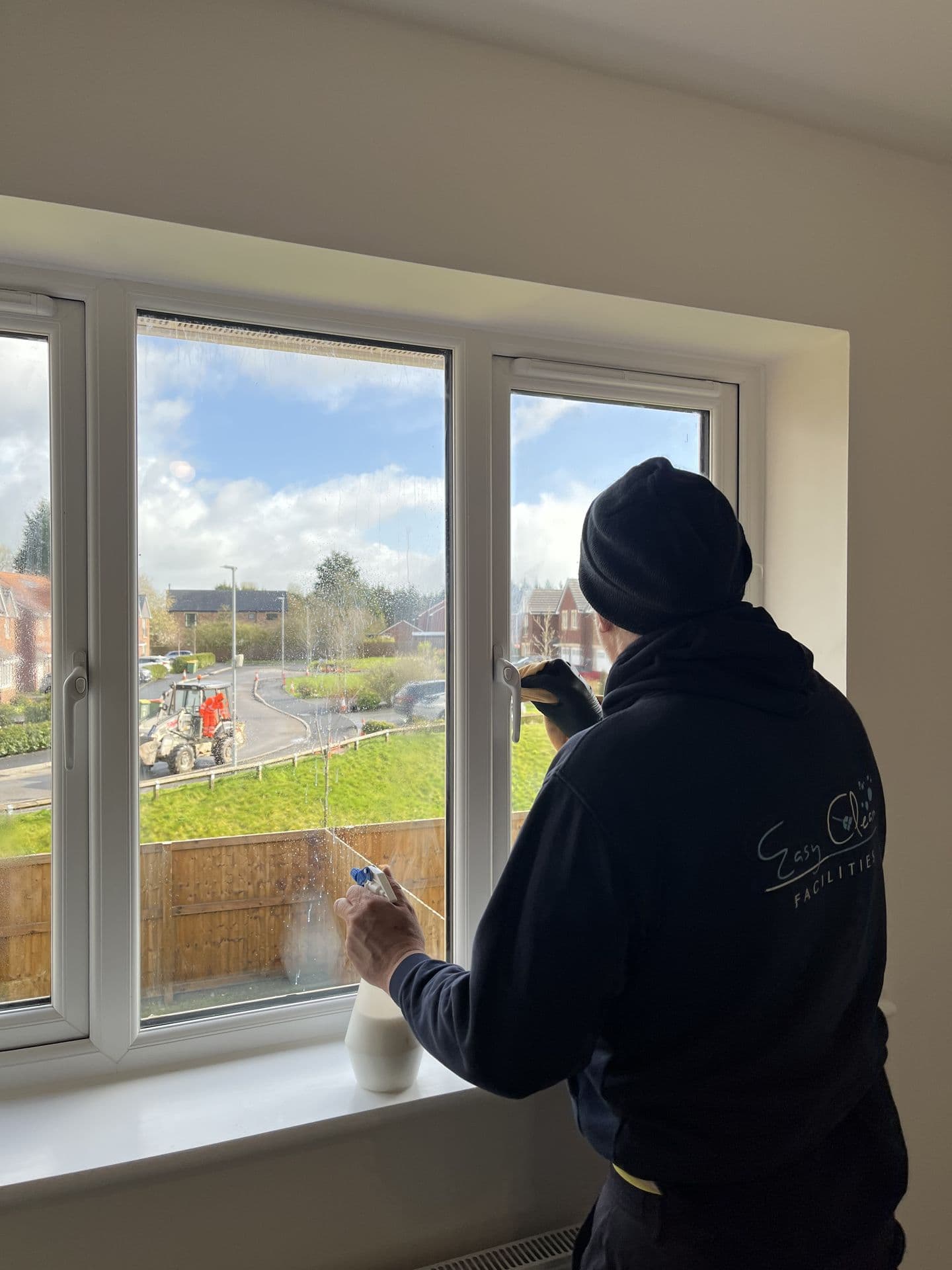 Easy Clean team member cleaning a window in an empty property